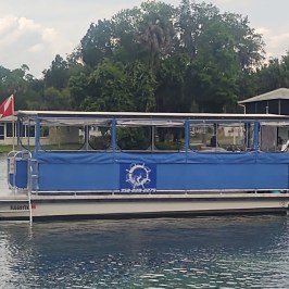 a blue boat docked next to a body of water