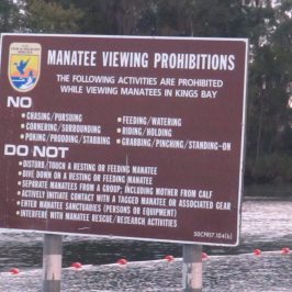 a sign on the side of the water