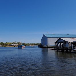 a boat is docked next to a body of water